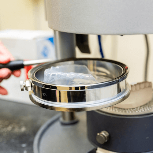 dental guards being created from a dental mold.