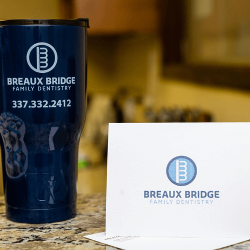 A Breaux Bridge Family Density cup and card.