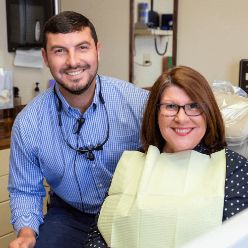 Dentist smiling with patient.