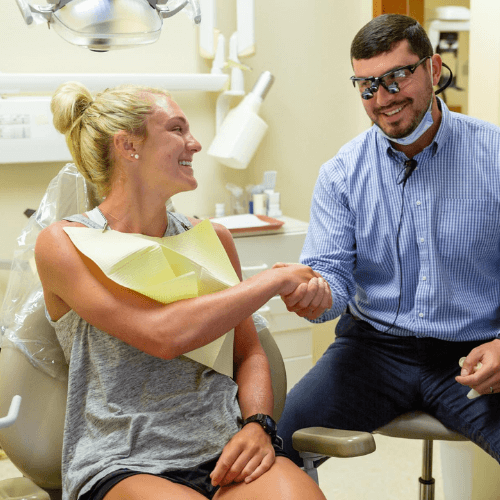 Dentist shaking hands with patient.