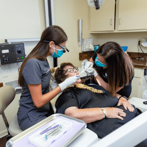 two hygienist cleaning a patients teeth