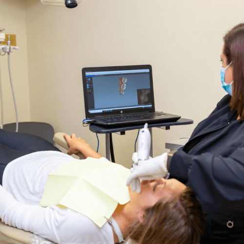 dental assistant scanning a patients teeth