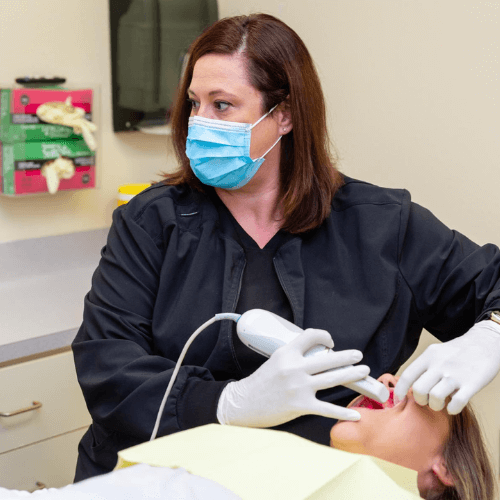 dental assistant scanning a clients teeth