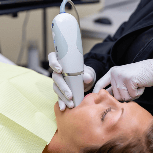 dental assistant taking scans of clients teeth