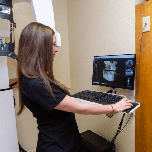 dental assistant looking at xrays