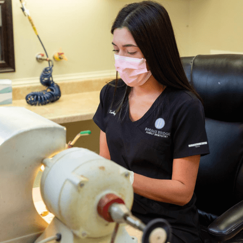 hygienist working at front desk.