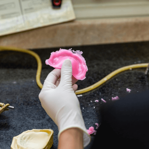 denture in the hand of a dentist.